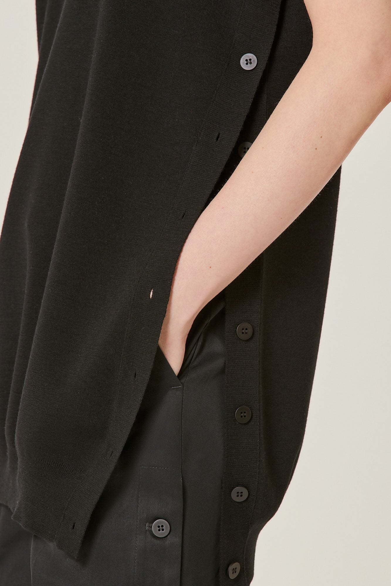 Sleeveless virgin wool top with side buttons